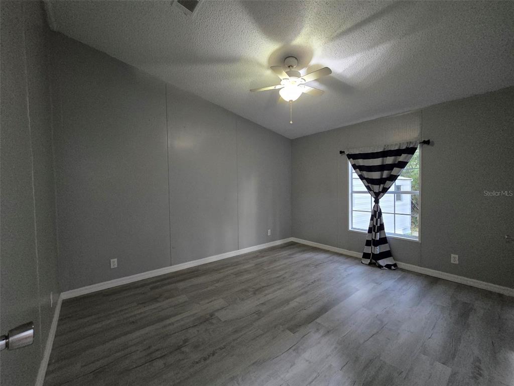 55921 Fern Road Astor, FL 32102 - Photo 15 of 24 a view of room with a window and a ceiling fan