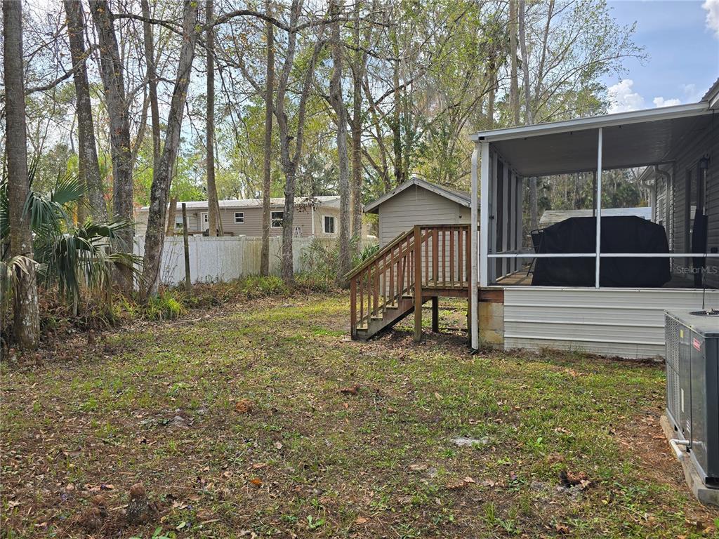 55921 Fern Road Astor, FL 32102 - Photo 20 of 24 a house with trees in front of it