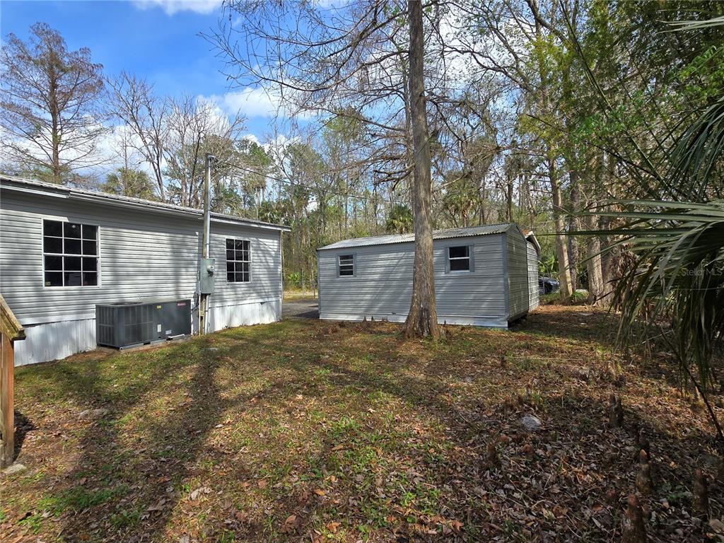 55921 Fern Road Astor, FL 32102 - Photo 21 of 24 a view of a backyard with large tree
