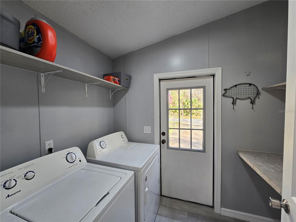 55921 Fern Road Astor, FL 32102 - Photo 3 of 24 a utility room with dryer and washer