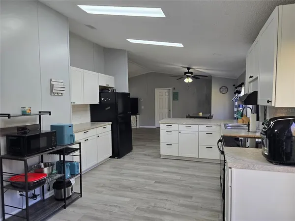 a kitchen with refrigerator and cabinets
