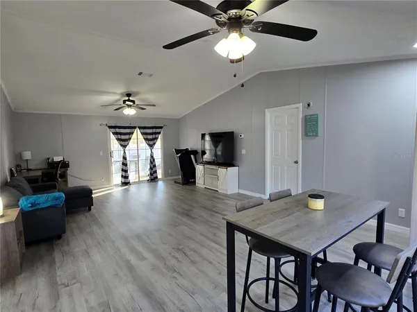 a view of a dining room with furniture and wooden floor