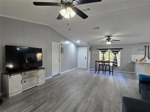 a view of a livingroom with furniture and a flat screen tv