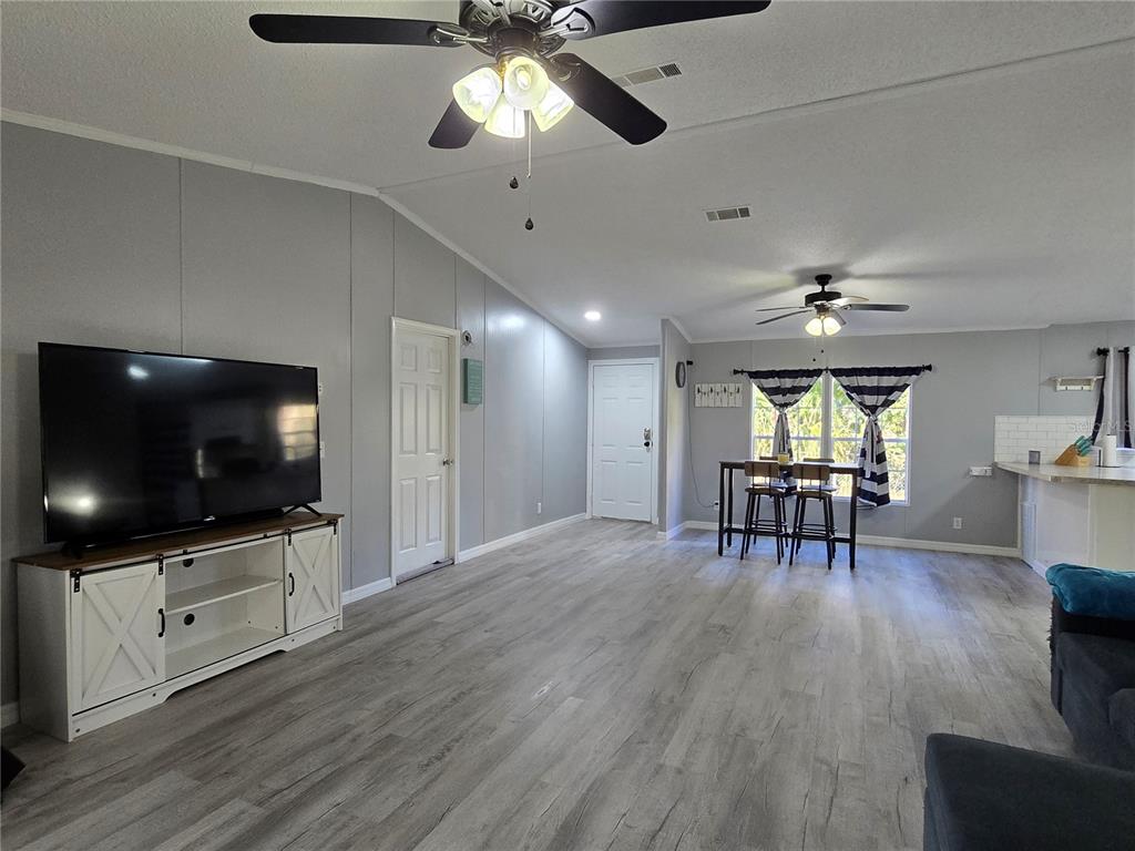 55921 Fern Road Astor, FL 32102 - Photo 9 of 24 a view of a livingroom with furniture and a flat screen tv