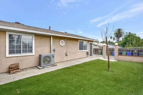a backyard of a house with table and chairs