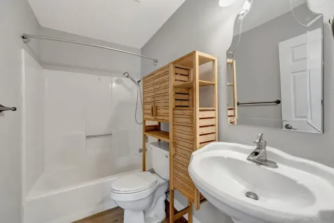 a bathroom with a sink toilet and shower