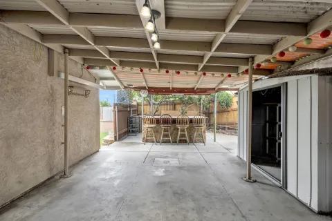 a view of a patio with table and chairs and potted plants