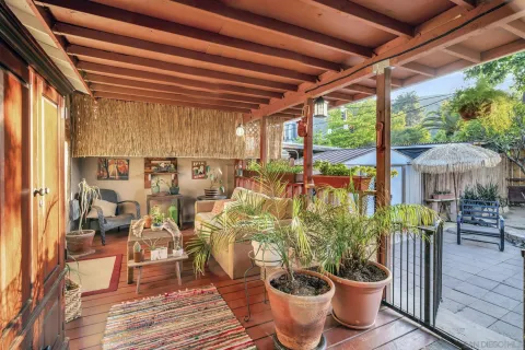 a view of patio with a table and chairs and a barbeque