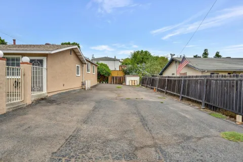a view of a house with wooden fence