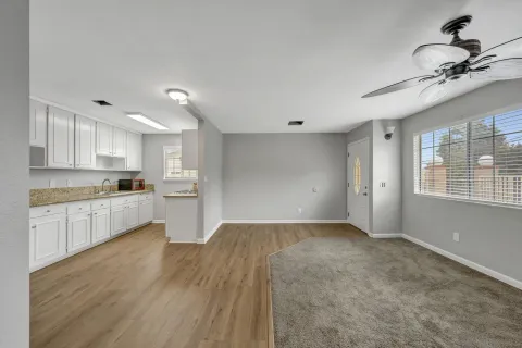 a kitchen with white cabinets and white appliances