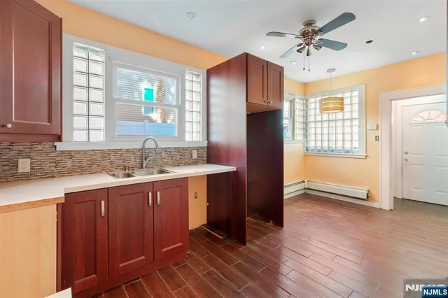 a kitchen with granite countertop a refrigerator and a sink