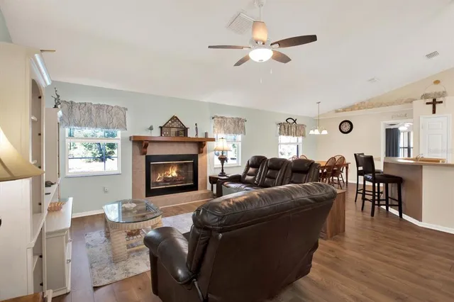 a living room with furniture a fireplace and a flat screen tv