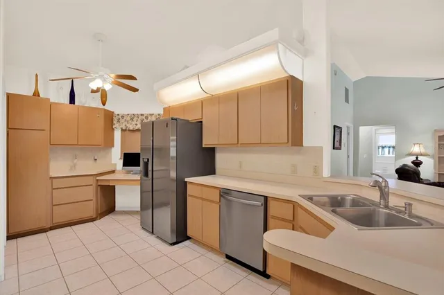 a kitchen with a sink appliances and cabinets