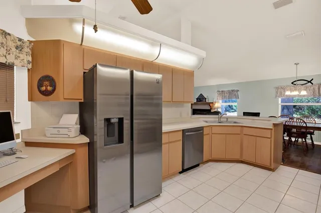 a kitchen with stainless steel appliances granite countertop a refrigerator and a sink