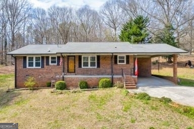 701 Burnette Road Carnesville, GA 30521 - Photo 1 of 1 a front view of a house with garden