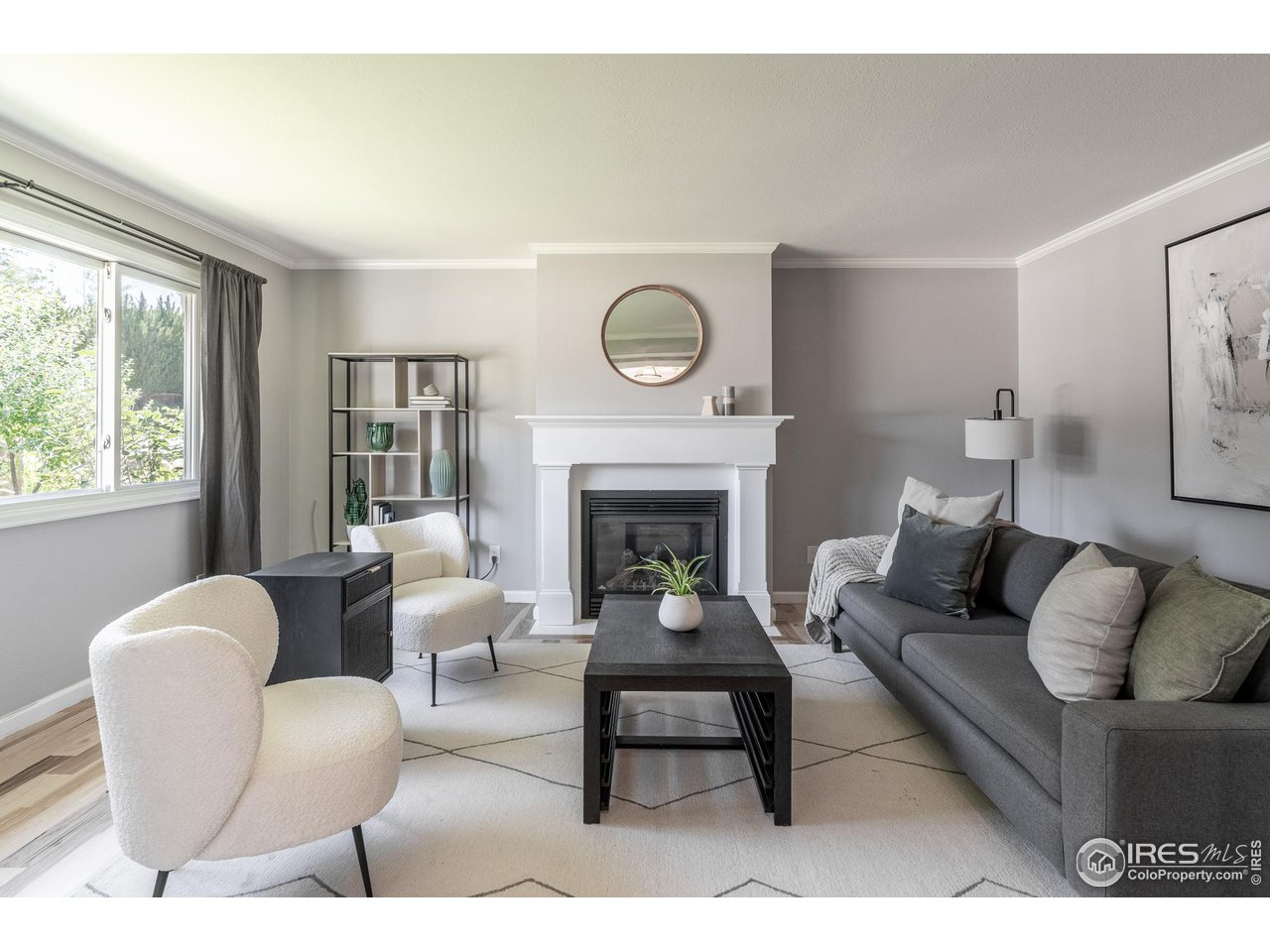 a living room with furniture a large window and a fireplace