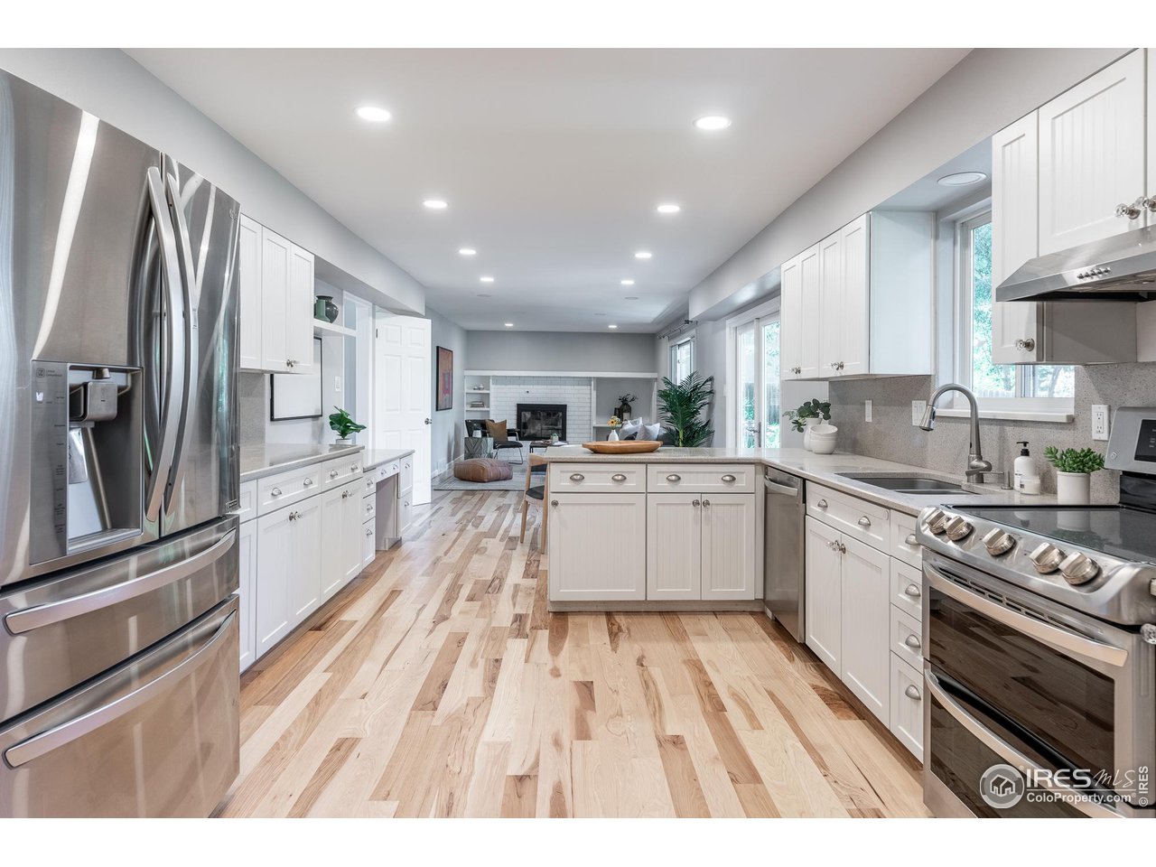 7357 Glacier View Road Longmont, CO 80503 - Photo 13 of 39 a large kitchen with stainless steel appliances lot of white cabinets