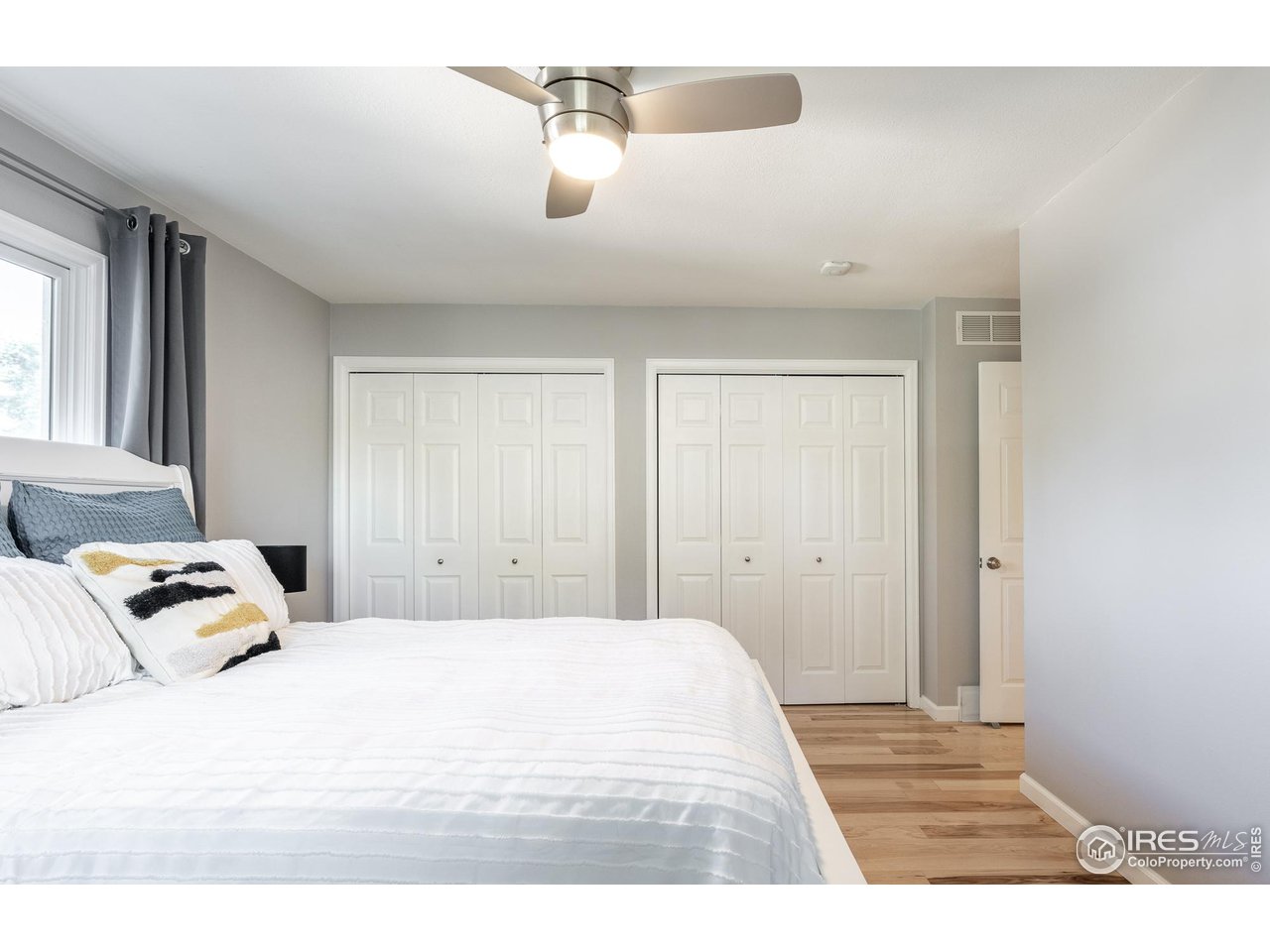 7357 Glacier View Road Longmont, CO 80503 - Photo 19 of 39 a bedroom with a bed and a night stand