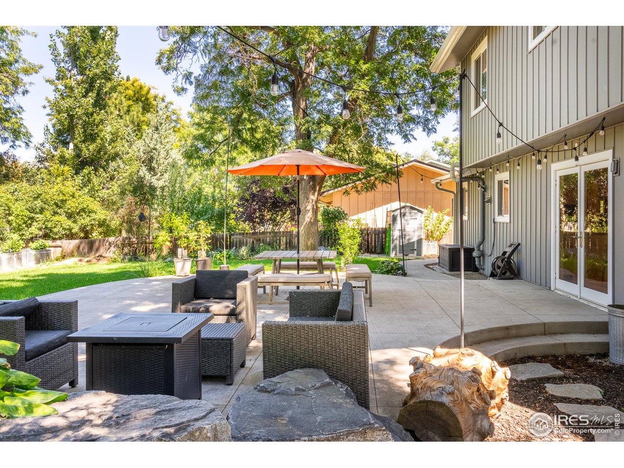 7357 Glacier View Road Longmont, CO 80503 - Photo 2 of 39 a view of a patio with couches and table and chairs with wooden fence