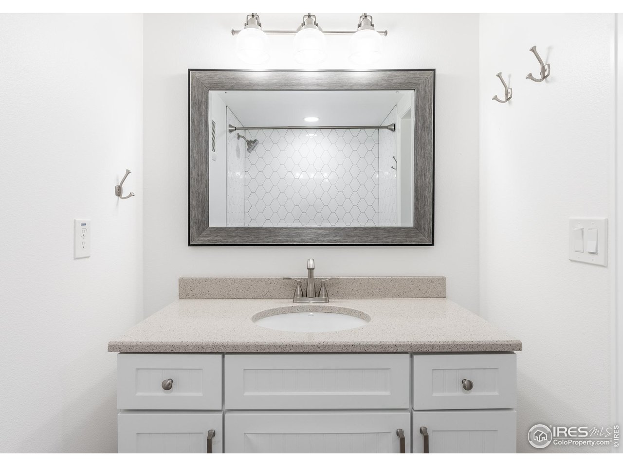 7357 Glacier View Road Longmont, CO 80503 - Photo 30 of 39 a bathroom with a sink vanity and a mirror
