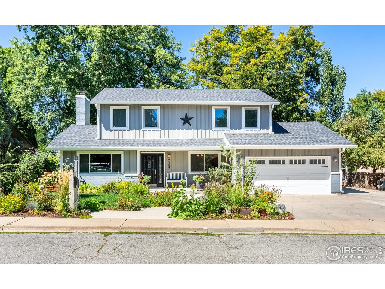 7357 Glacier View Road Longmont, CO 80503 - Photo 4 of 39 a front view of a house with a garden