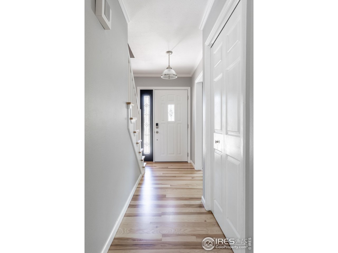 7357 Glacier View Road Longmont, CO 80503 - Photo 7 of 39 a view of a hallway with wooden floor and entryway
