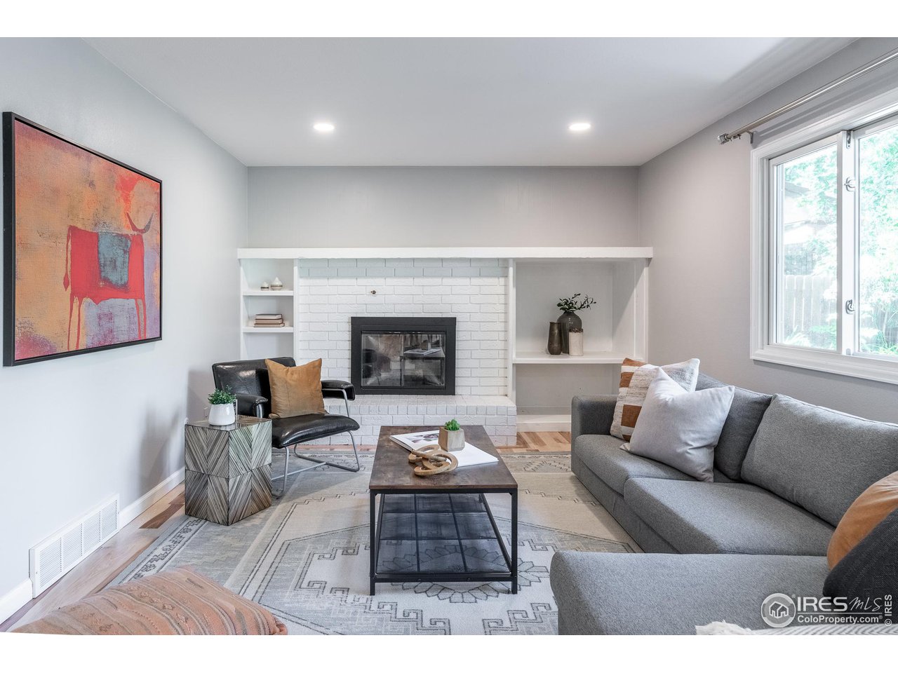 7357 Glacier View Road Longmont, CO 80503 - Photo 9 of 39 a living room with furniture dining area and a fireplace