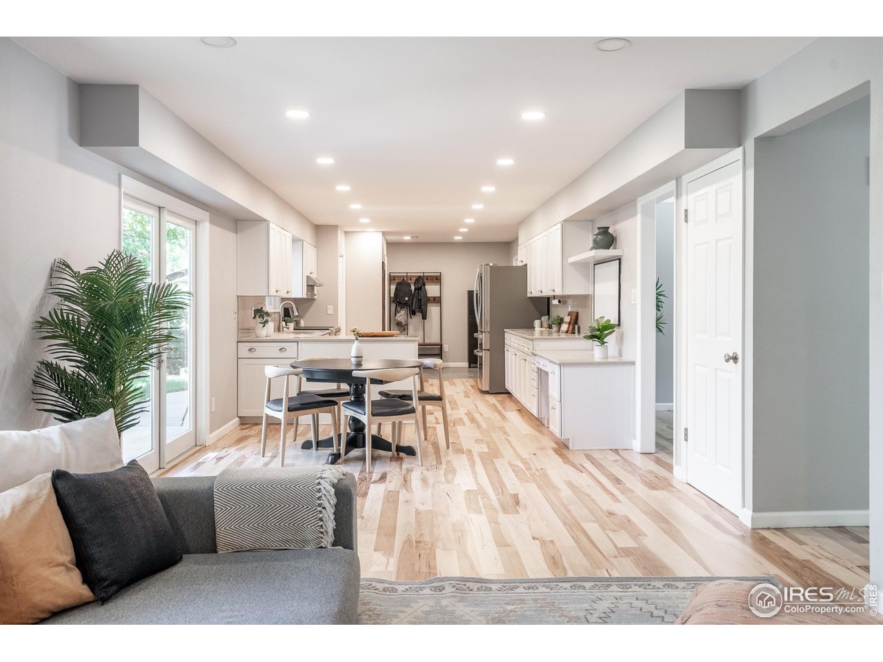 7357 Glacier View Road Longmont, CO 80503 - Photo 10 of 39 a living room with furniture and view of kitchen