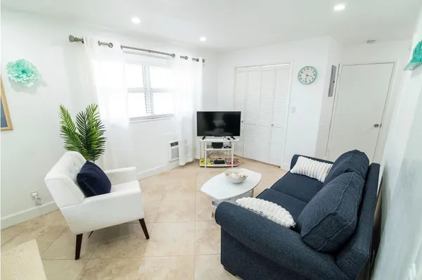 a living room with furniture and a flat screen tv