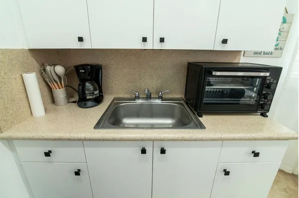 a kitchen with sink and cabinets