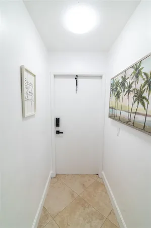 a view of a hallway with paintings on the wall