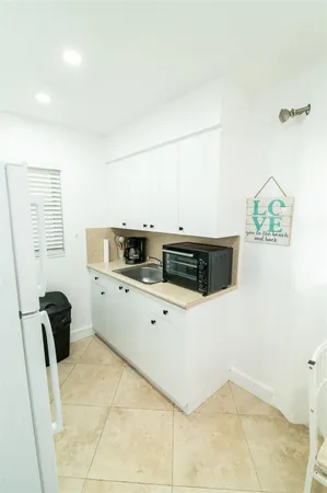 a kitchen with stainless steel appliances a stove a microwave a sink and a refrigerator