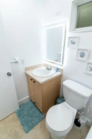 a white toilet sitting next to a bathroom sink
