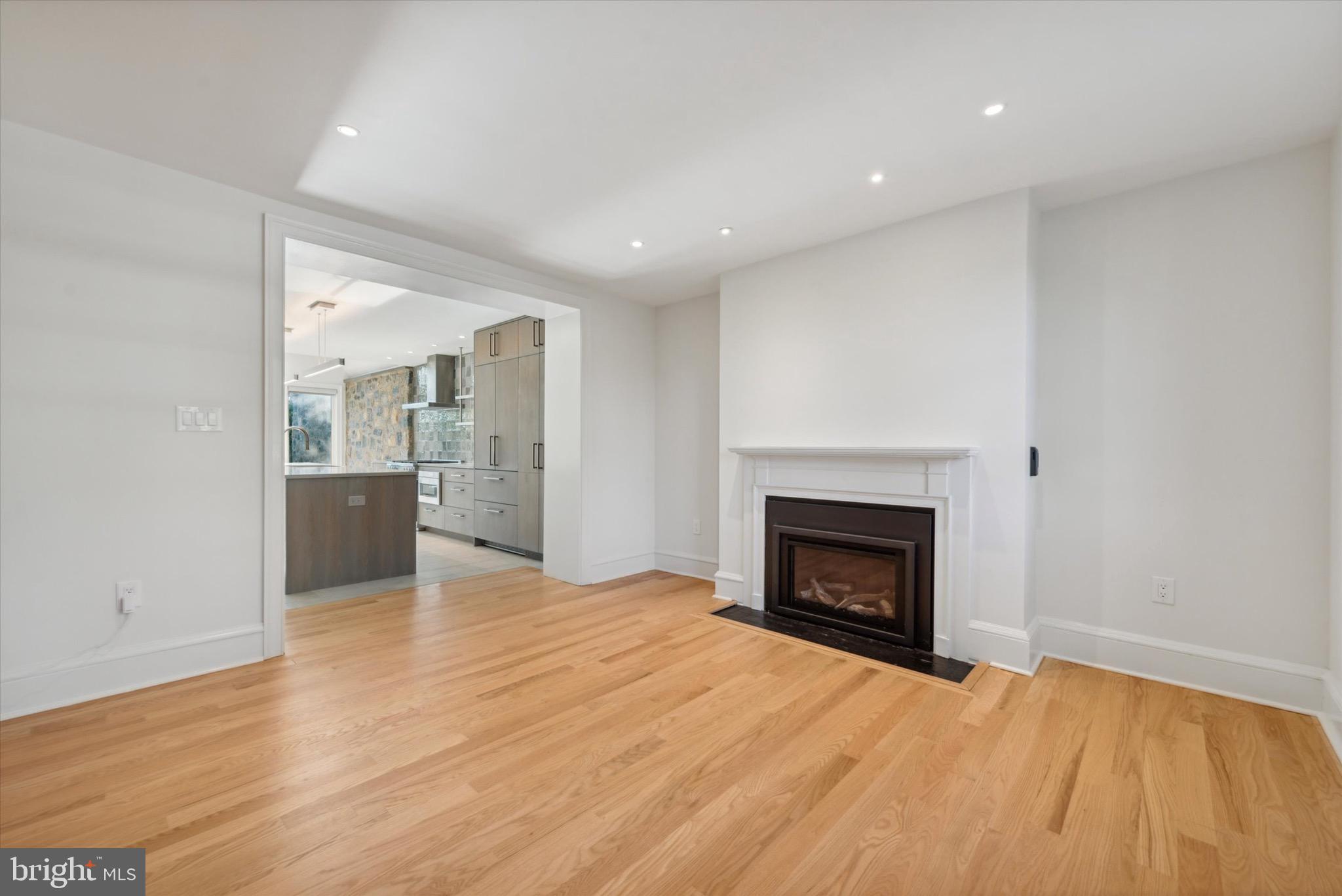 767-769 Newtown Road Villanova, PA 19085 - Photo 7 of 26 a view of an empty room with wooden floor fireplace and a window