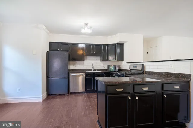 a kitchen with granite countertop stainless steel appliances and wooden cabinets