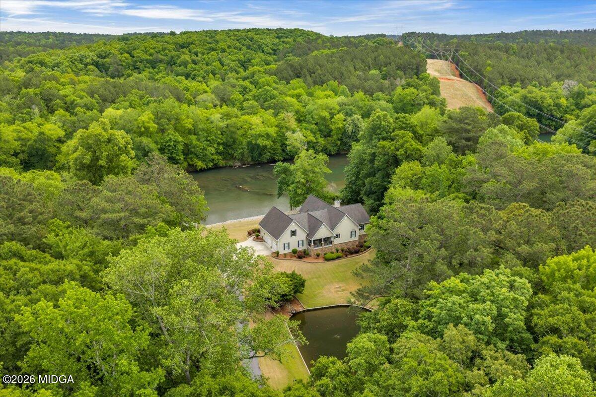 625 Rum Creek Road Juliette, GA 31046 - Photo 12 of 81 a view of a lake with a house in a yard