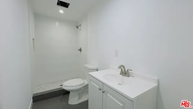 a bathroom with a sink toilet and a mirror