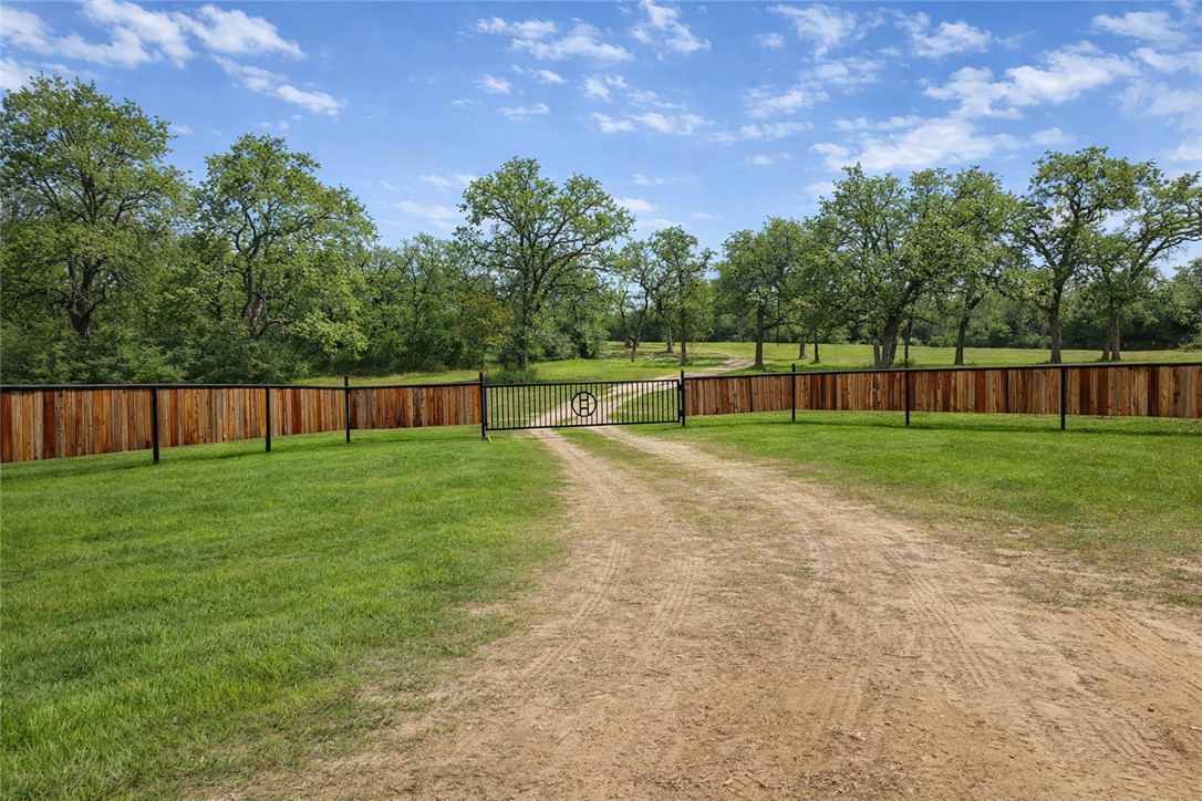 7031 Red Rock Road Franklin, TX 77856 - Photo 2 of 17 a swimming pool with wooden fence