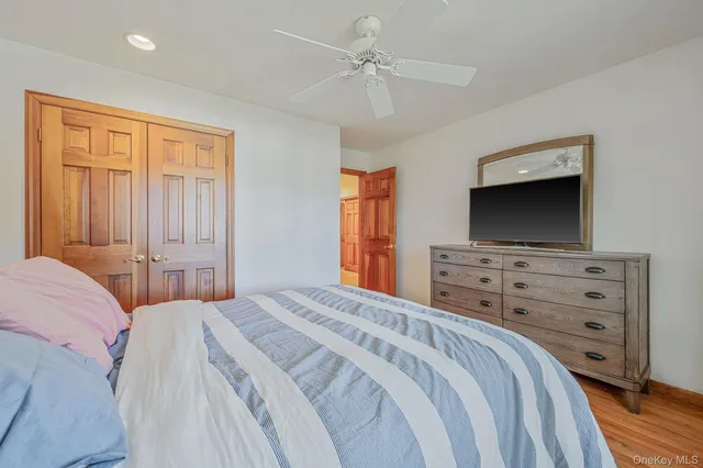 a bedroom with furniture and a flat screen tv