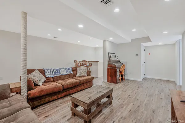 a kitchen with a refrigerator sink stove and white cabinets