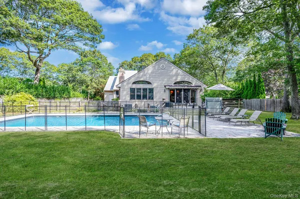 a view of a house with backyard and sitting area