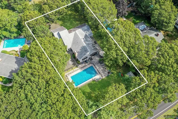 an aerial view of a house with a yard and garden
