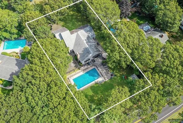 an aerial view of a house with a yard and garden
