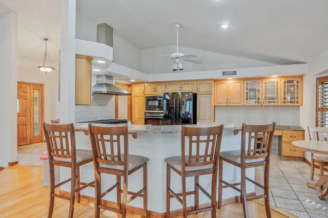 a large kitchen with cabinets and wooden floor