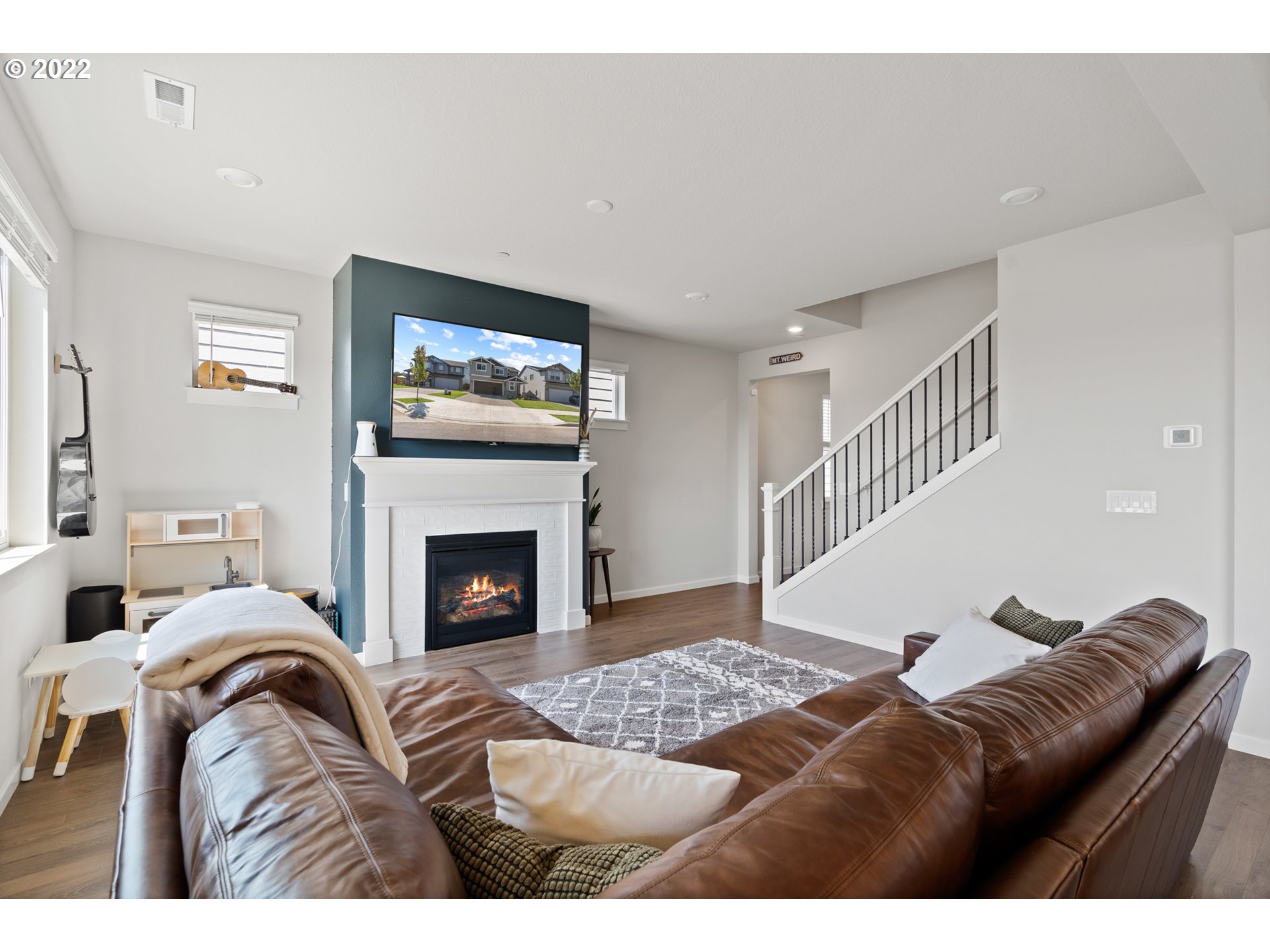 6690 North 89th Loop Camas, WA 98607 - Photo 11 of 24 a living room with furniture a fireplace and a flat screen tv