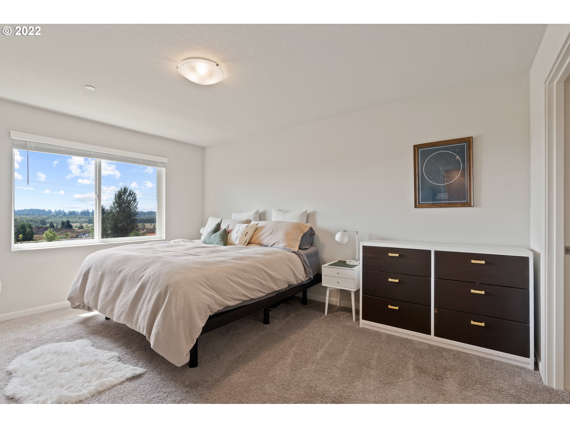 6690 North 89th Loop Camas, WA 98607 - Photo 14 of 24 a bedroom with a bed and a large window