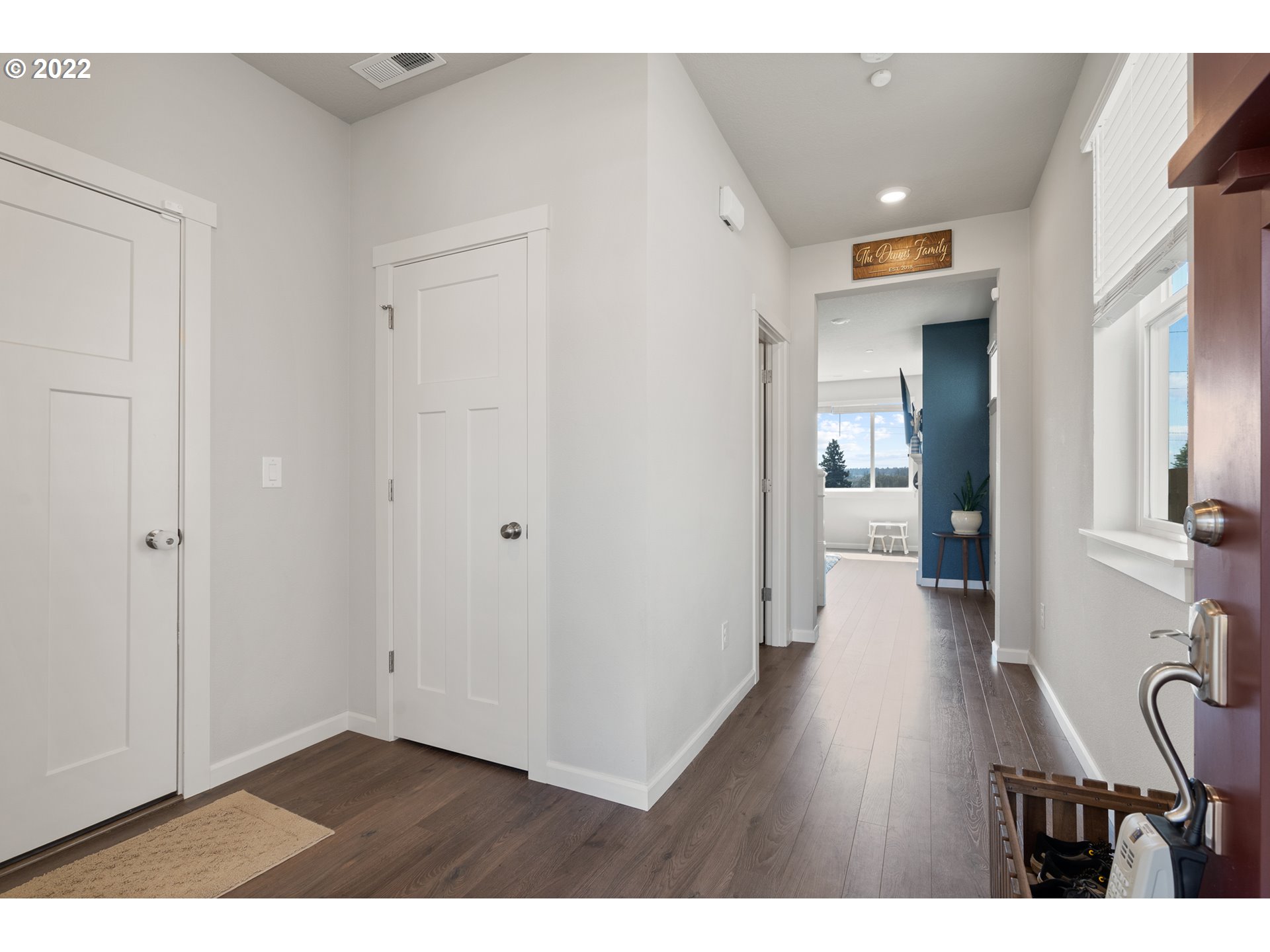 6690 North 89th Loop Camas, WA 98607 - Photo 3 of 24 a view of a hallway with wooden floor and furniture