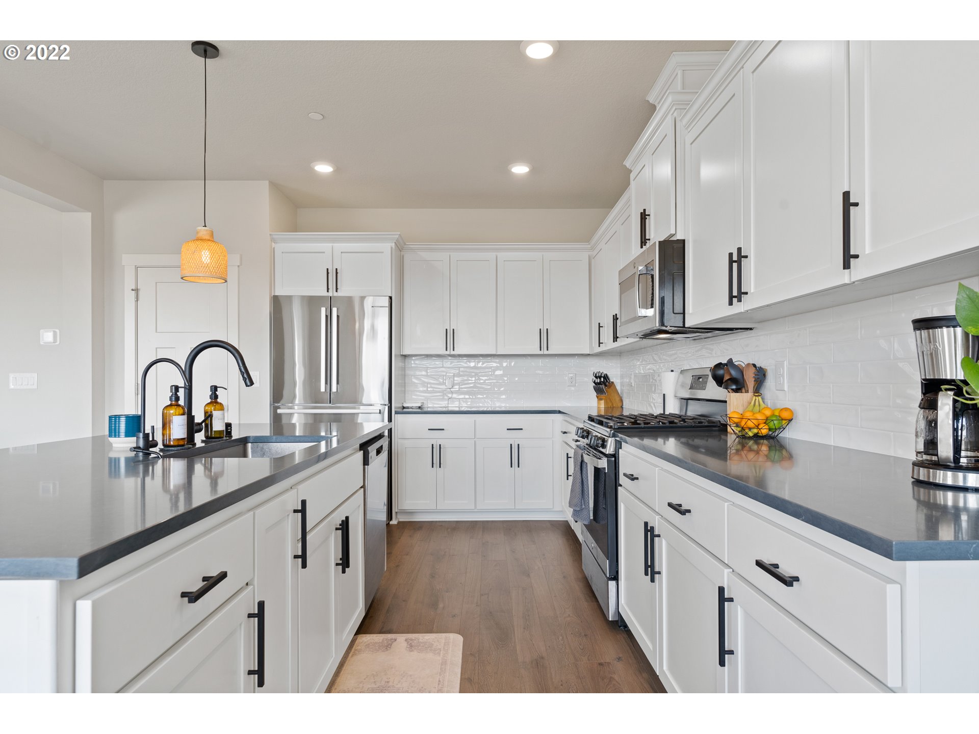 6690 North 89th Loop Camas, WA 98607 - Photo 8 of 24 a kitchen with white cabinets appliances and a sink