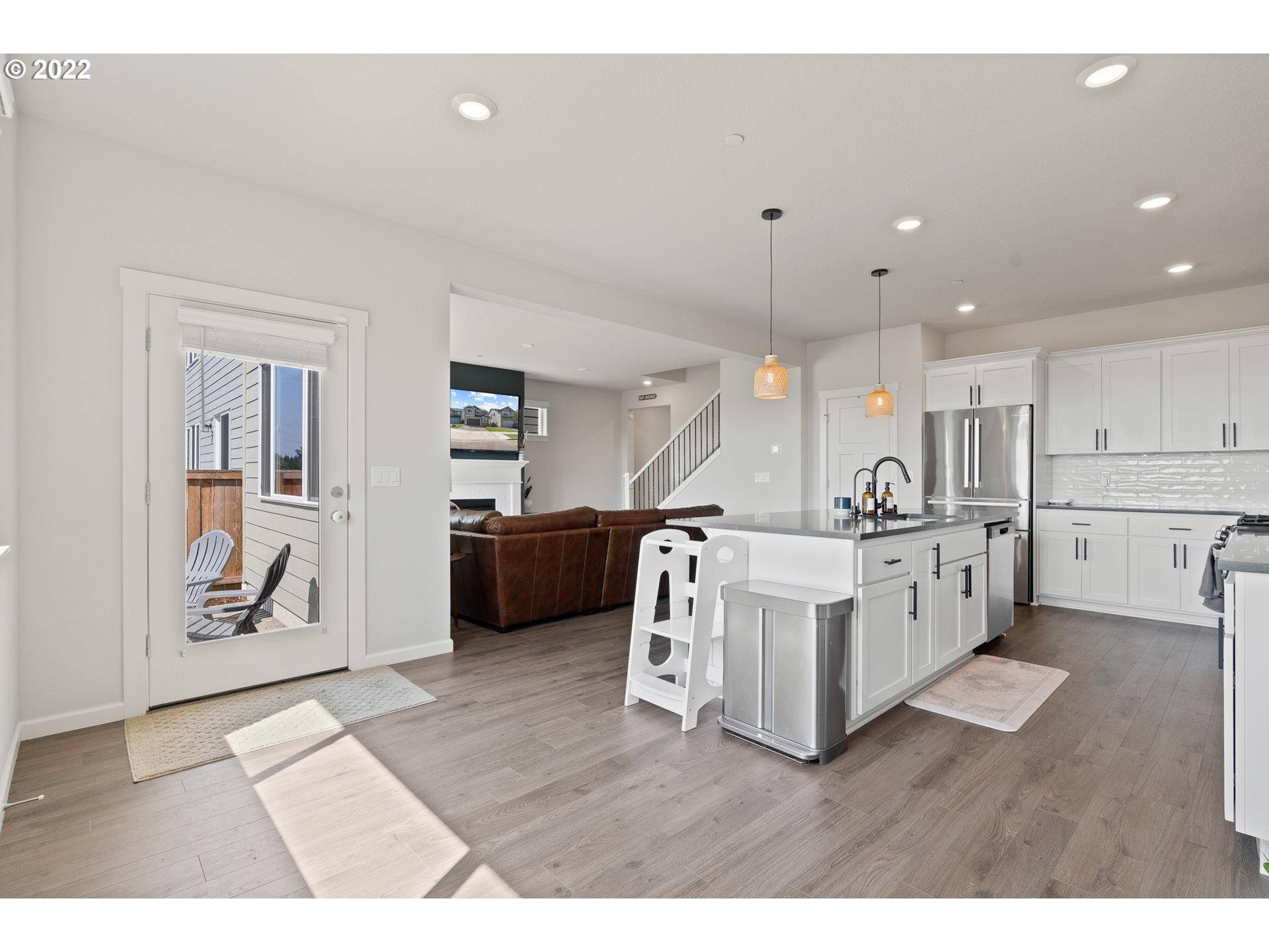 6690 North 89th Loop Camas, WA 98607 - Photo 10 of 24 a view of a kitchen with furniture and refrigerator