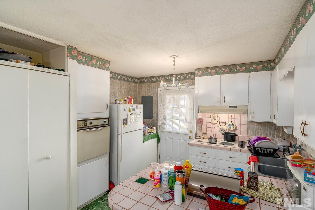 1412 North King Charles Road Raleigh, NC 27610 - Photo 22 of 23 a kitchen with refrigerator and window